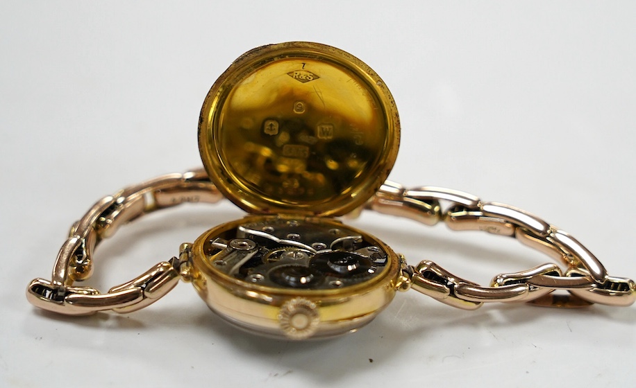 A lady's early 20th century 9ct gold manual wind wrist watch, with Arabic dial, on a 9ct expanding bracelet, gross weight 21.7 grams. Condition - fair to good